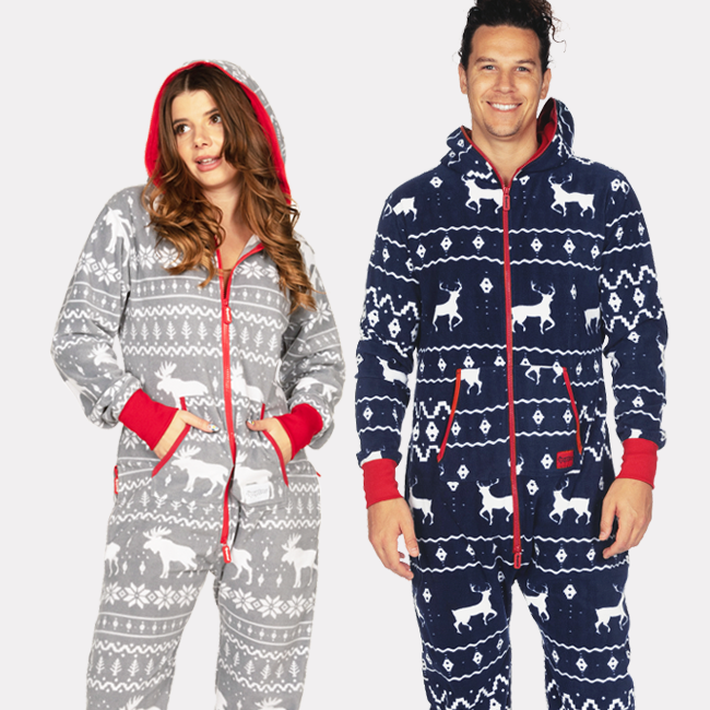 shop onesies - image of a woman wearing a gree moose jumpsuit and a man wearing a blue reindeer jumpsuit